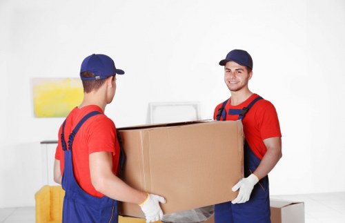 Moving team managing flat access and furniture removal in Old Oak Common