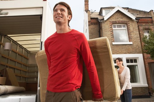 Loading household furniture into a removal van in Old Oak Common