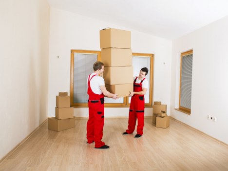 Local movers loading household items for transport in West London